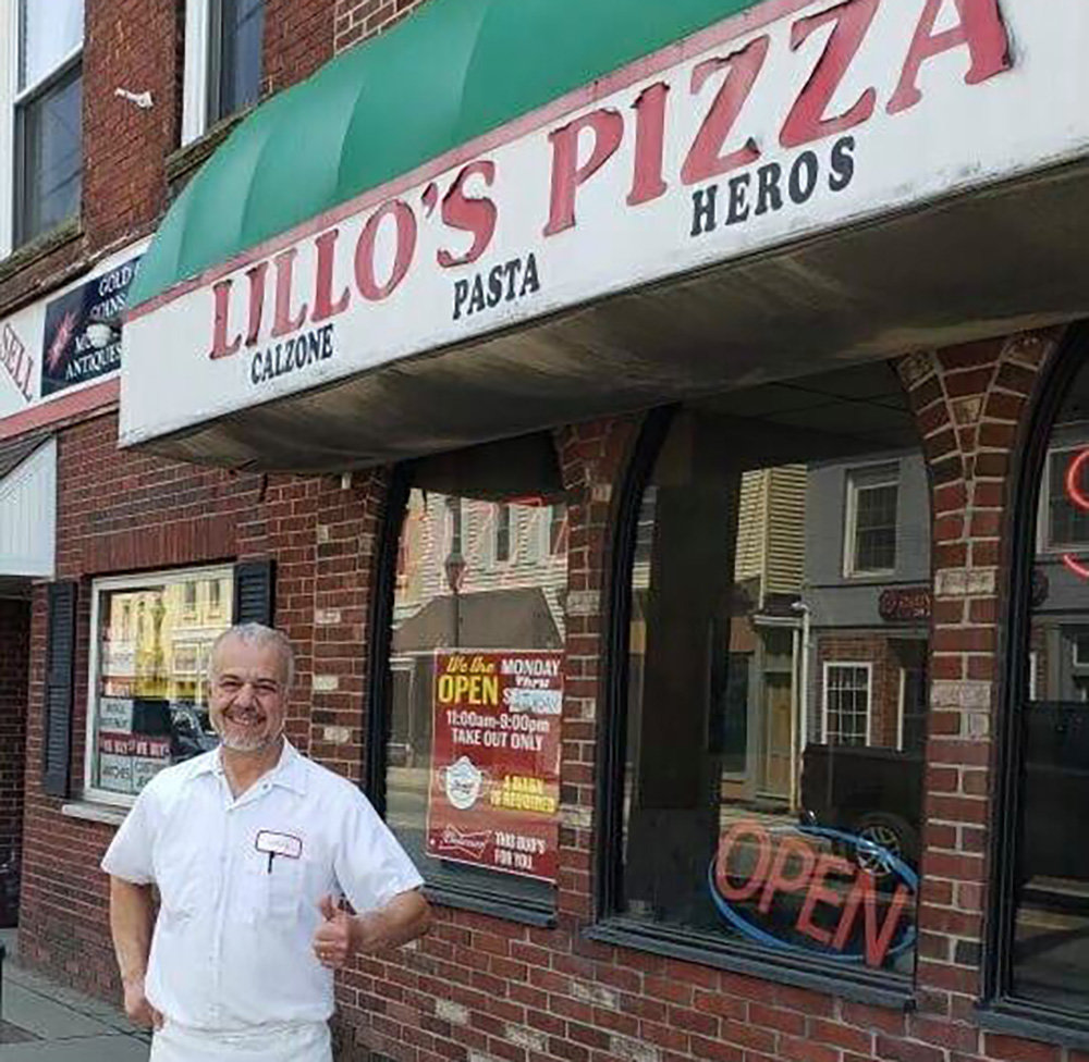 Lillo Calvaruso poses in front of Lillo’s Pizza, his business that he has owned for 46 years.